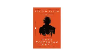 Okładka książki "Gdy Nietzsche płakał" Irvina D. Yalom z czarną sylwetką na pomarańczowym tle.